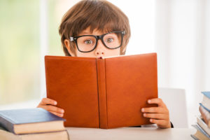 boy reading a book wide-eyed